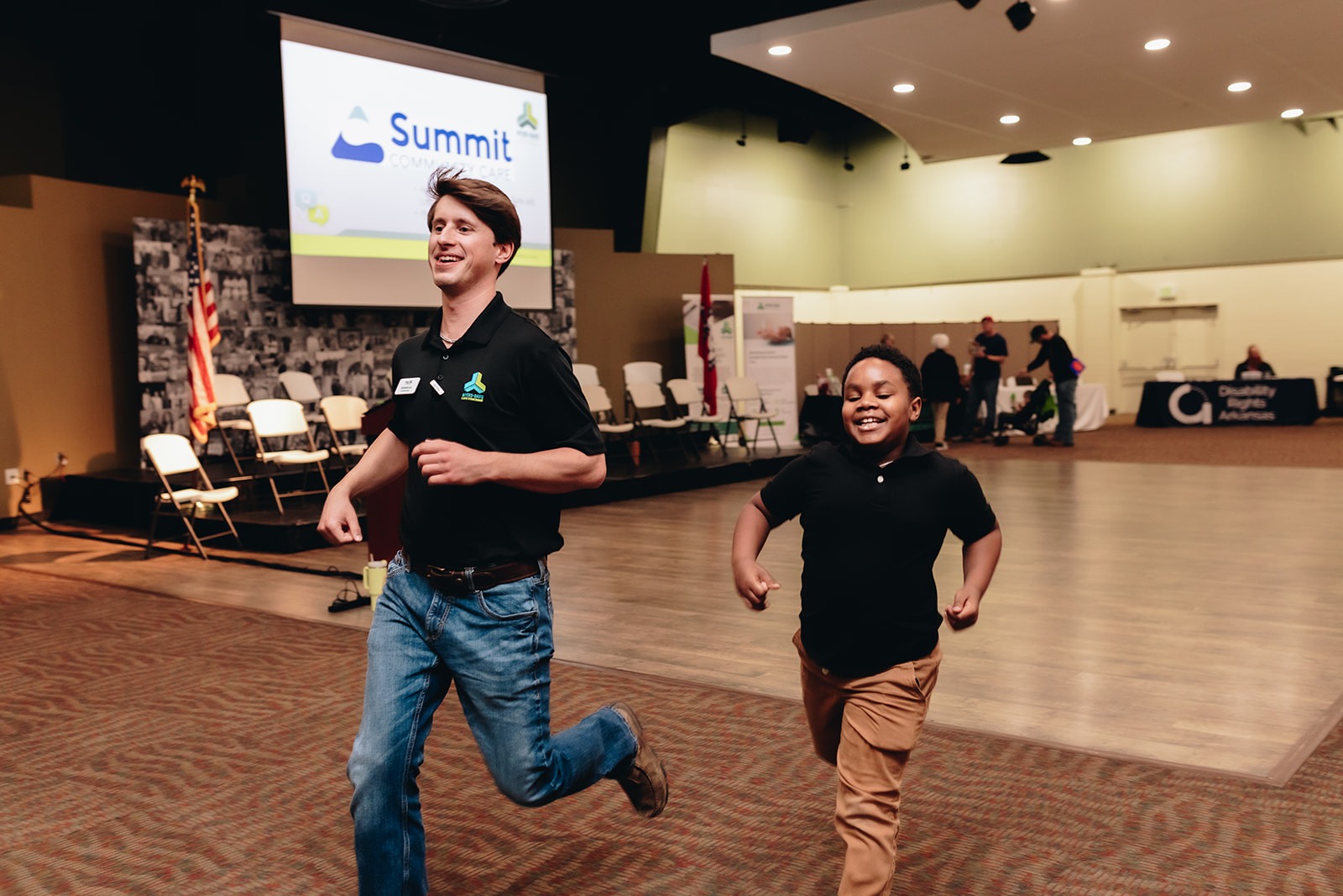 Myers Davis employee and child running indoors